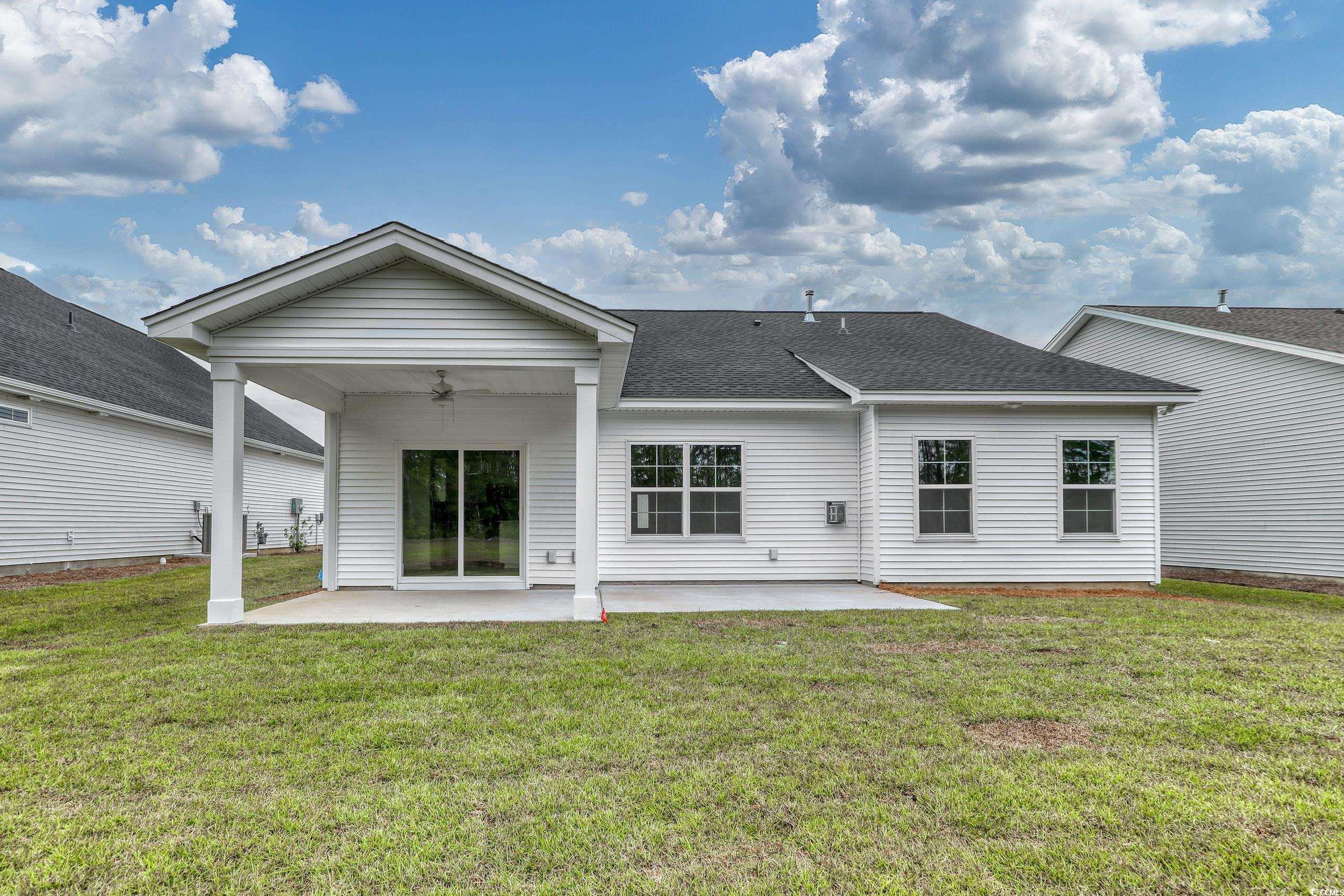 160 Azure Loop Myrtle Beach, SC 29588 - Photo 23 of 36 Rear view of property with a lawn, a patio, and ce