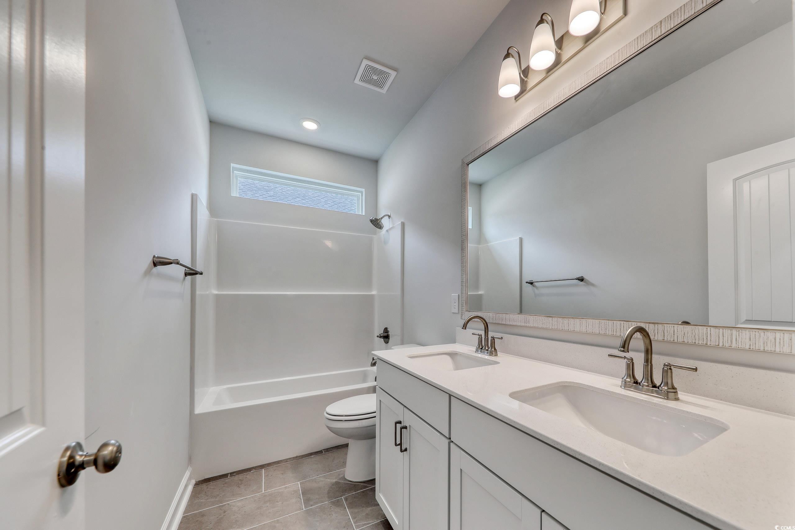 160 Azure Loop Myrtle Beach, SC 29588 - Photo 6 of 36 Full bathroom with vanity, tile patterned floors,