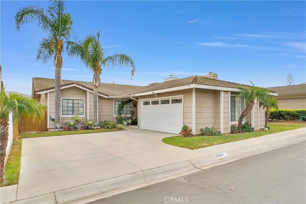 12042 Elk Boulevard Riverside, CA 92505 - Photo 1 of 1 a front view of a house with a yard and garage