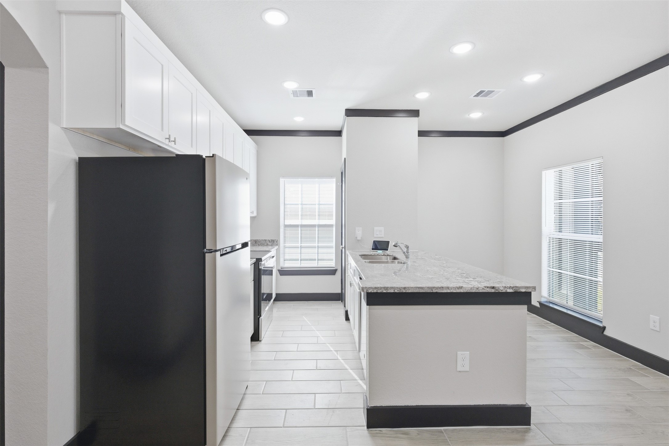 9412 Crofton Street, Unit B Houston, TX 77016 - Photo 14 of 20 a kitchen with stainless steel appliances a refrigerator and a sink