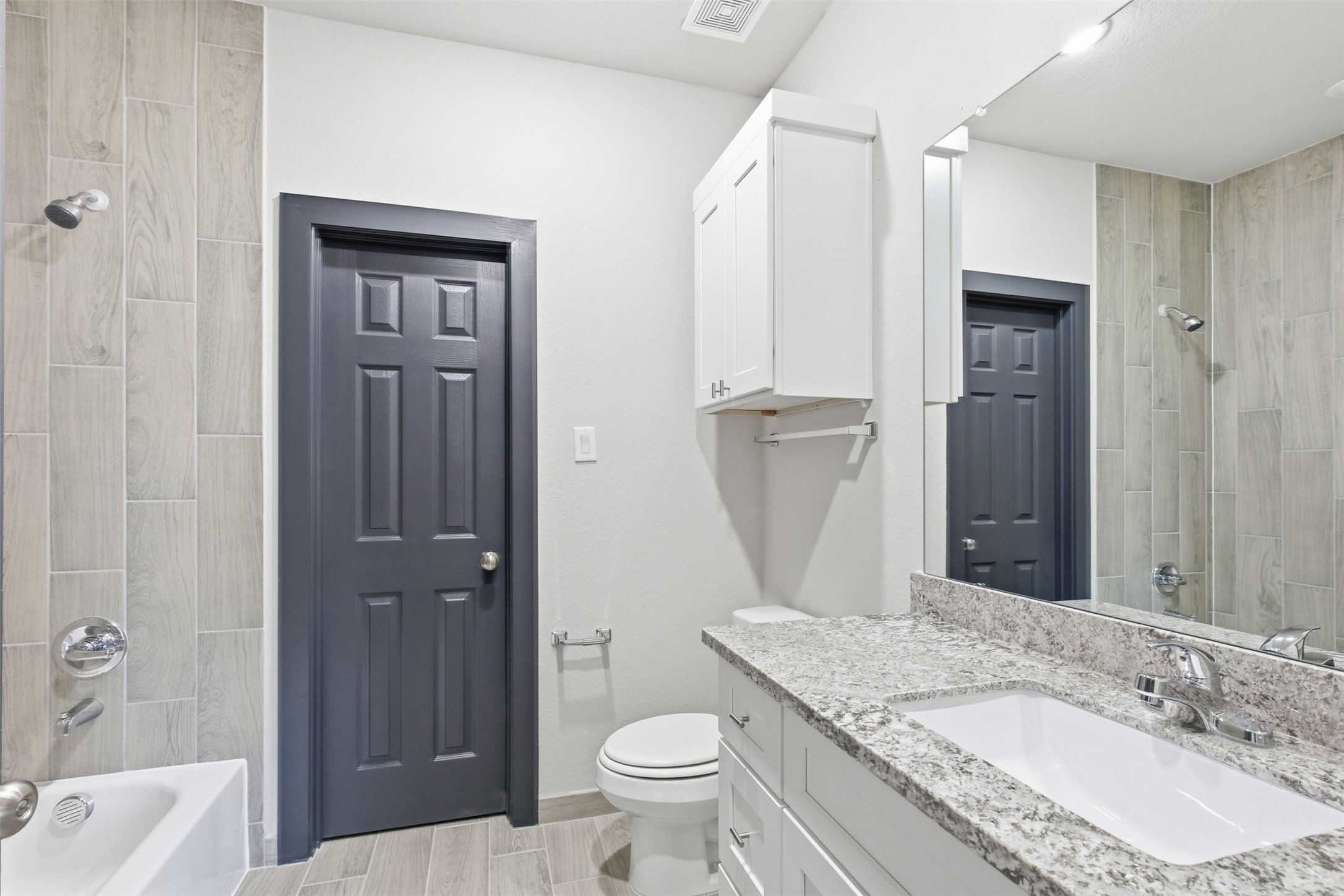 9412 Crofton Street, Unit B Houston, TX 77016 - Photo 16 of 20 a bathroom with a granite countertop sink toilet and shower