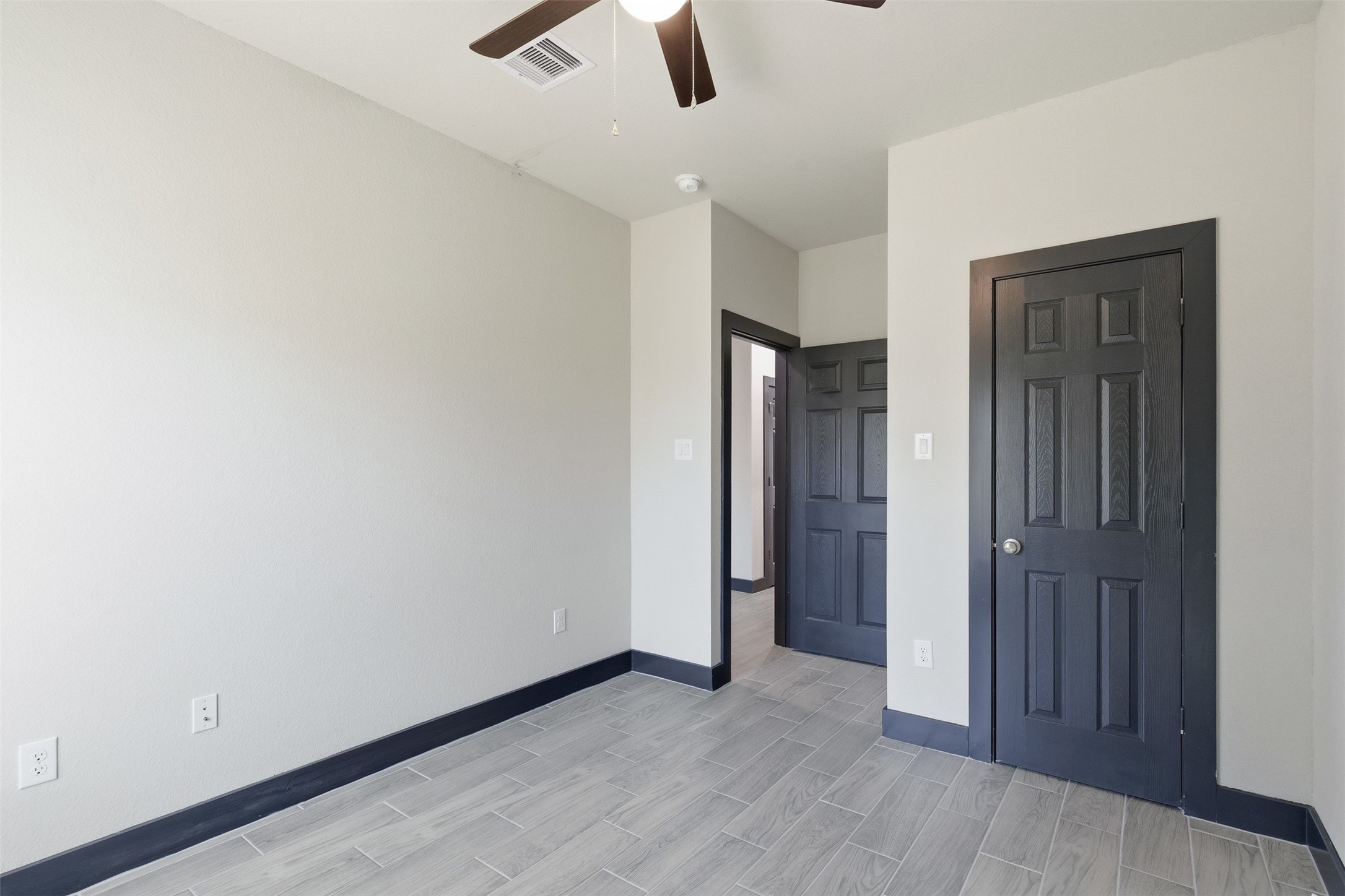9412 Crofton Street, Unit B Houston, TX 77016 - Photo 18 of 20 an empty room with ceiling fan and wooden floor