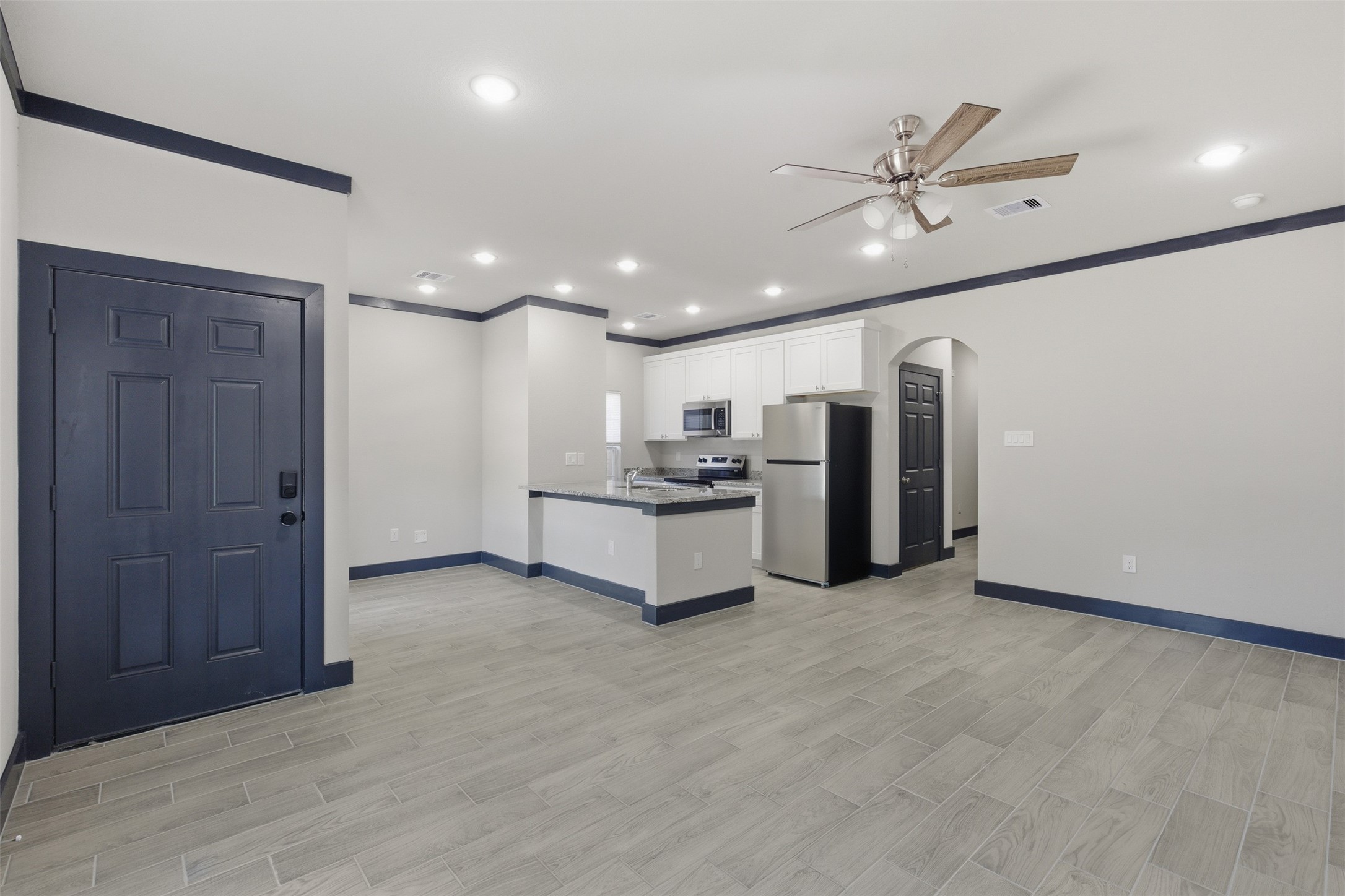 9412 Crofton Street, Unit B Houston, TX 77016 - Photo 3 of 20 a view of a kitchen with a sink and stainless steel appliances