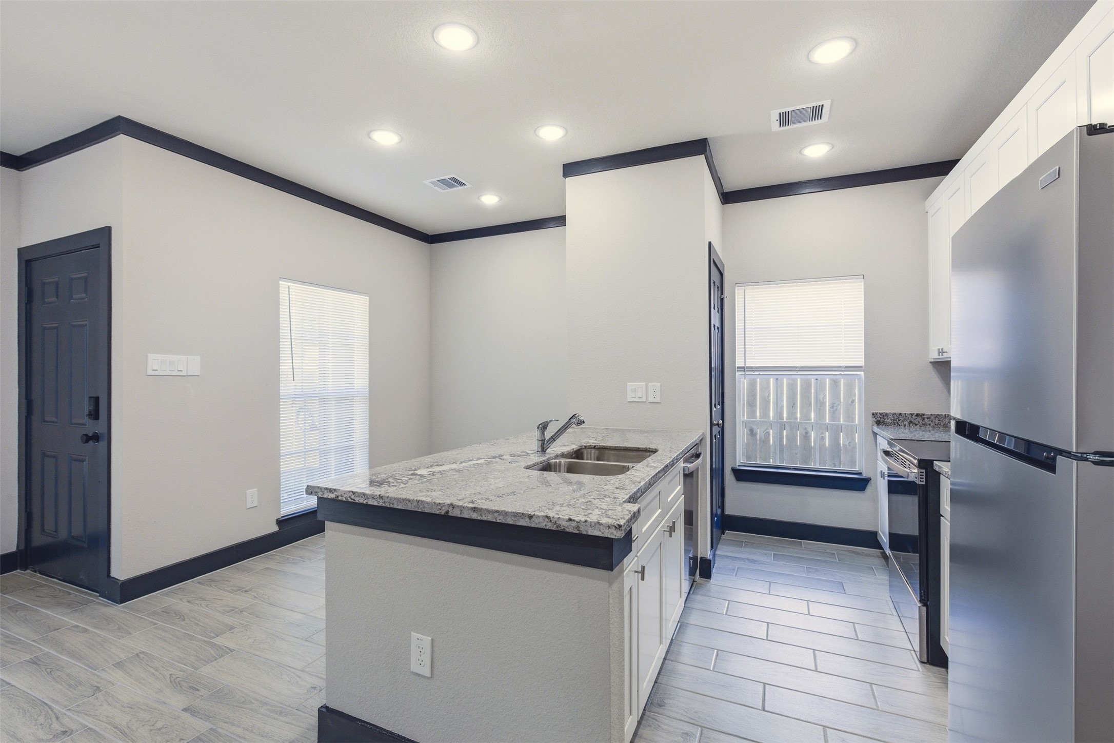 9412 Crofton Street, Unit B Houston, TX 77016 - Photo 4 of 20 a bathroom with a granite countertop sink a mirror and a toilet
