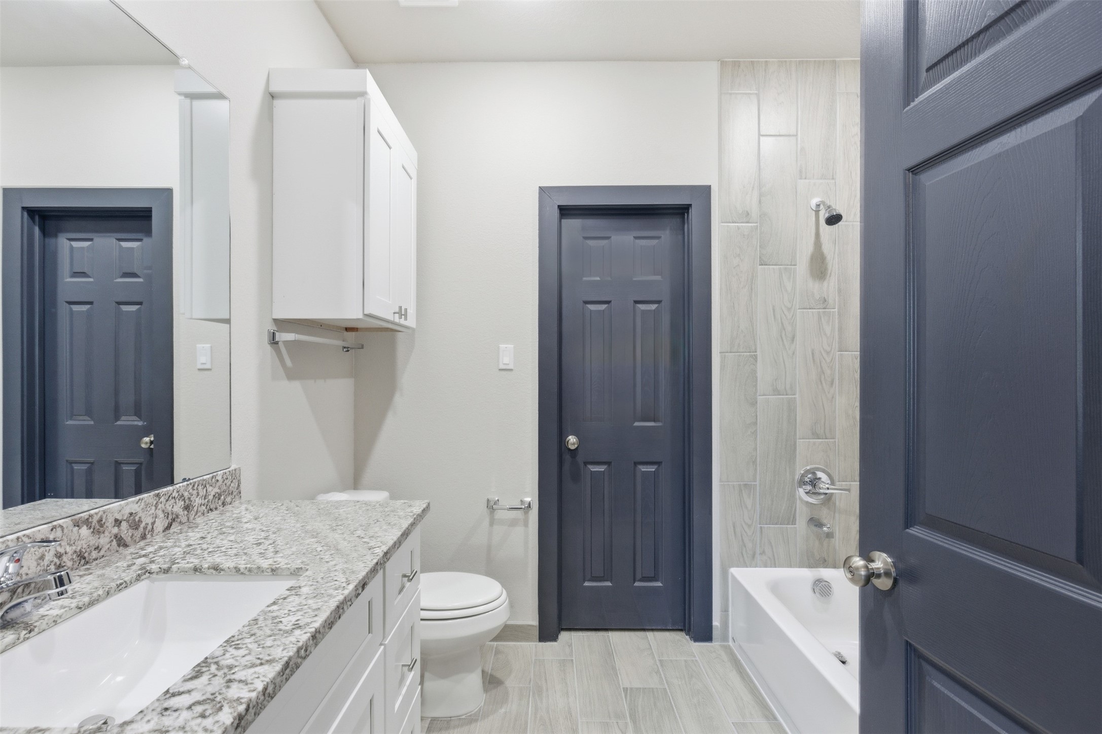 9412 Crofton Street, Unit B Houston, TX 77016 - Photo 8 of 20 a bathroom with a granite countertop sink a toilet and shower