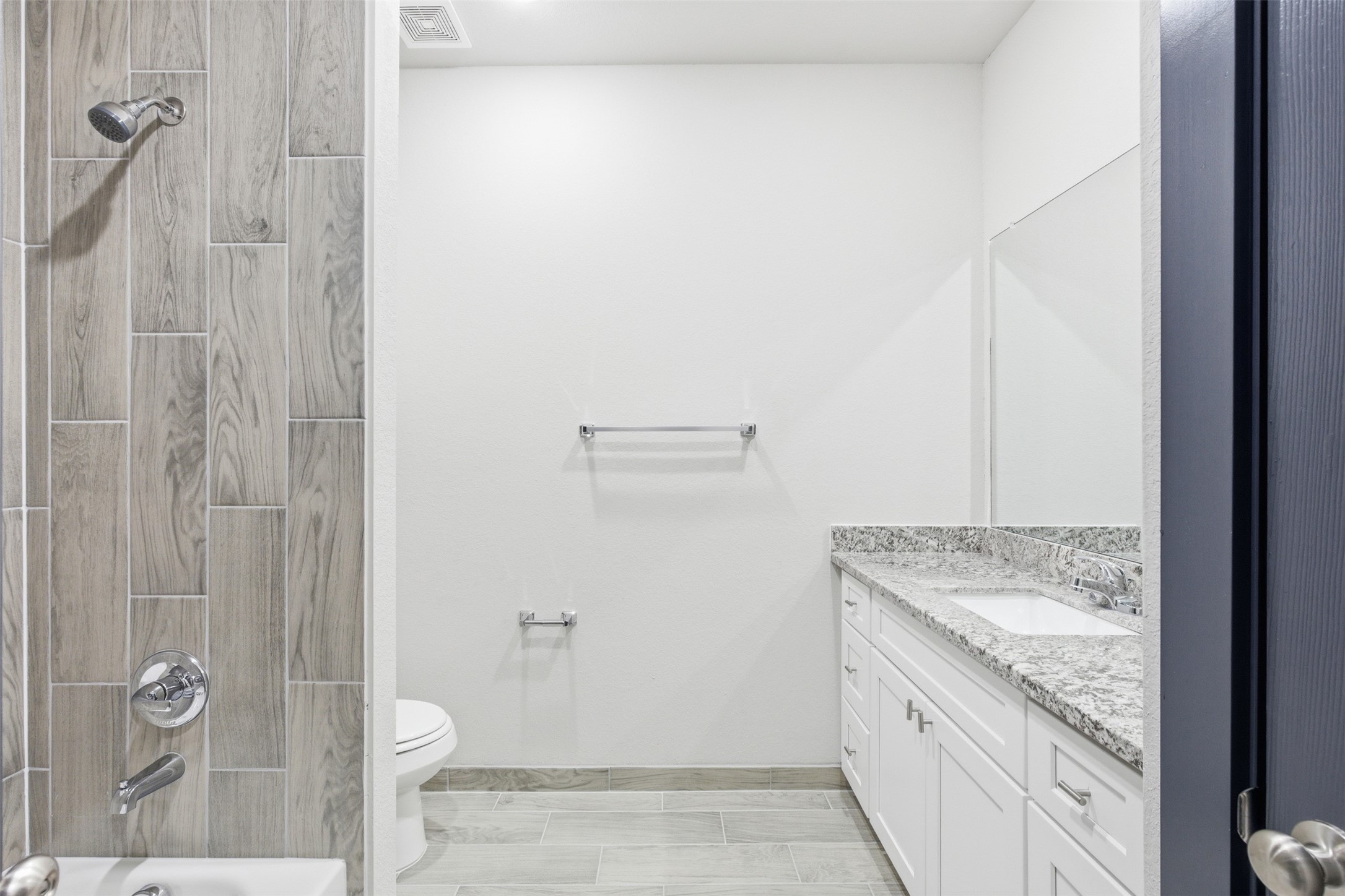 9412 Crofton Street, Unit B Houston, TX 77016 - Photo 9 of 20 a bathroom with a granite countertop sink a toilet and shower