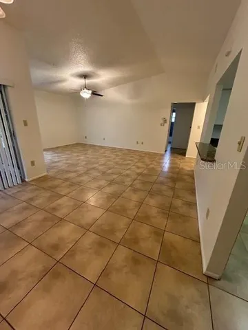 a view of a livingroom with kitchen and furniture