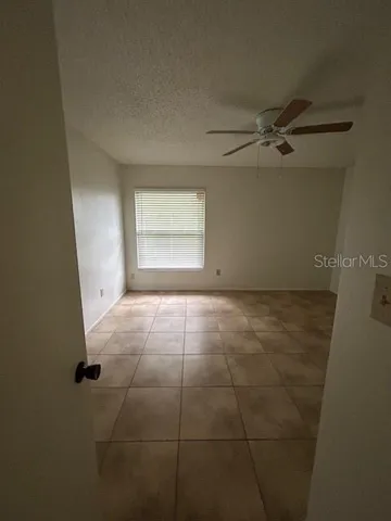 a view of an empty room and a window
