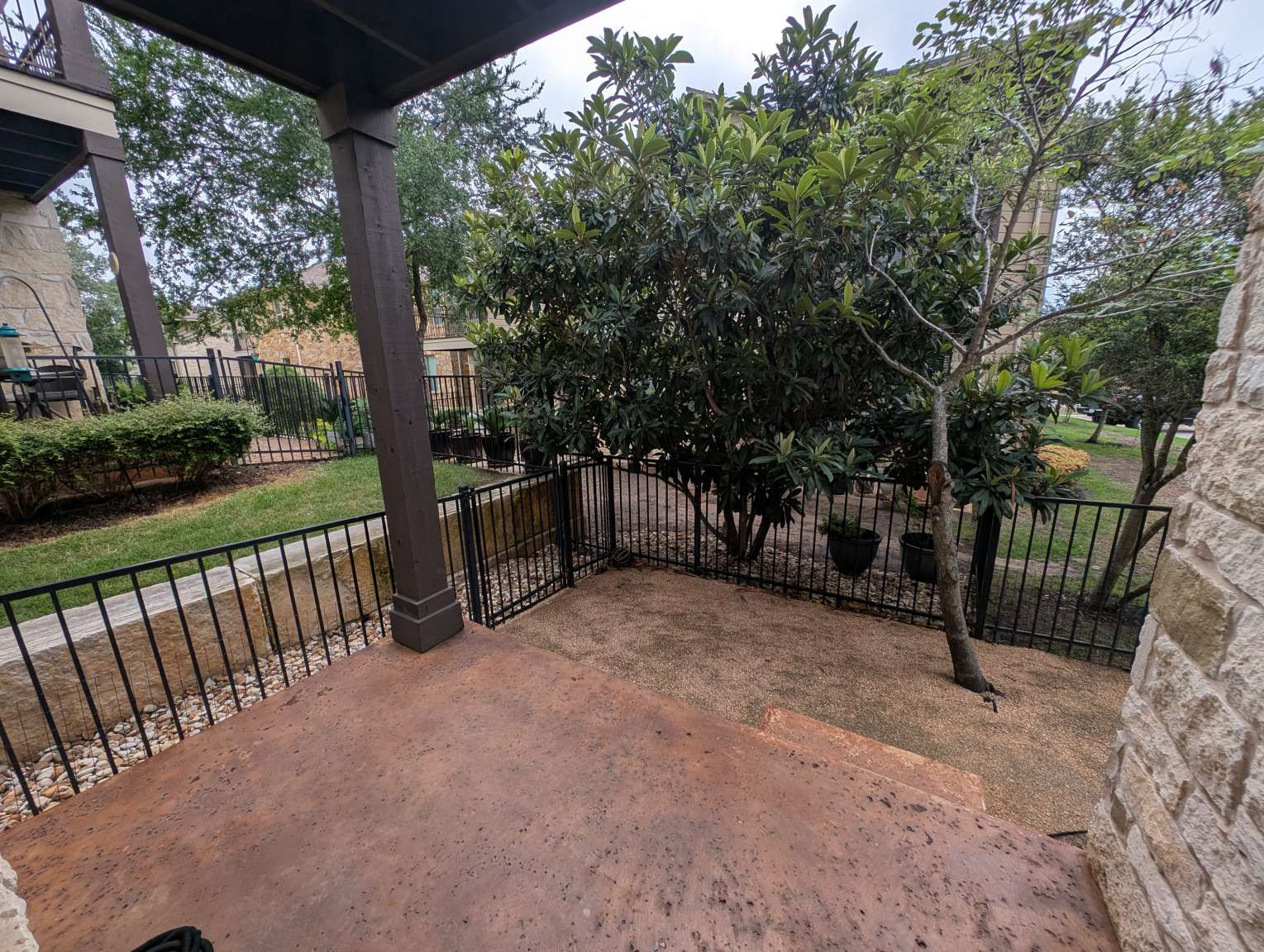 7301 Bandera Ranch Trail, Unit A Austin, TX 78750 - Photo 10 of 20 A private patio space extends into a neatly fenced yard with mature landscaping.