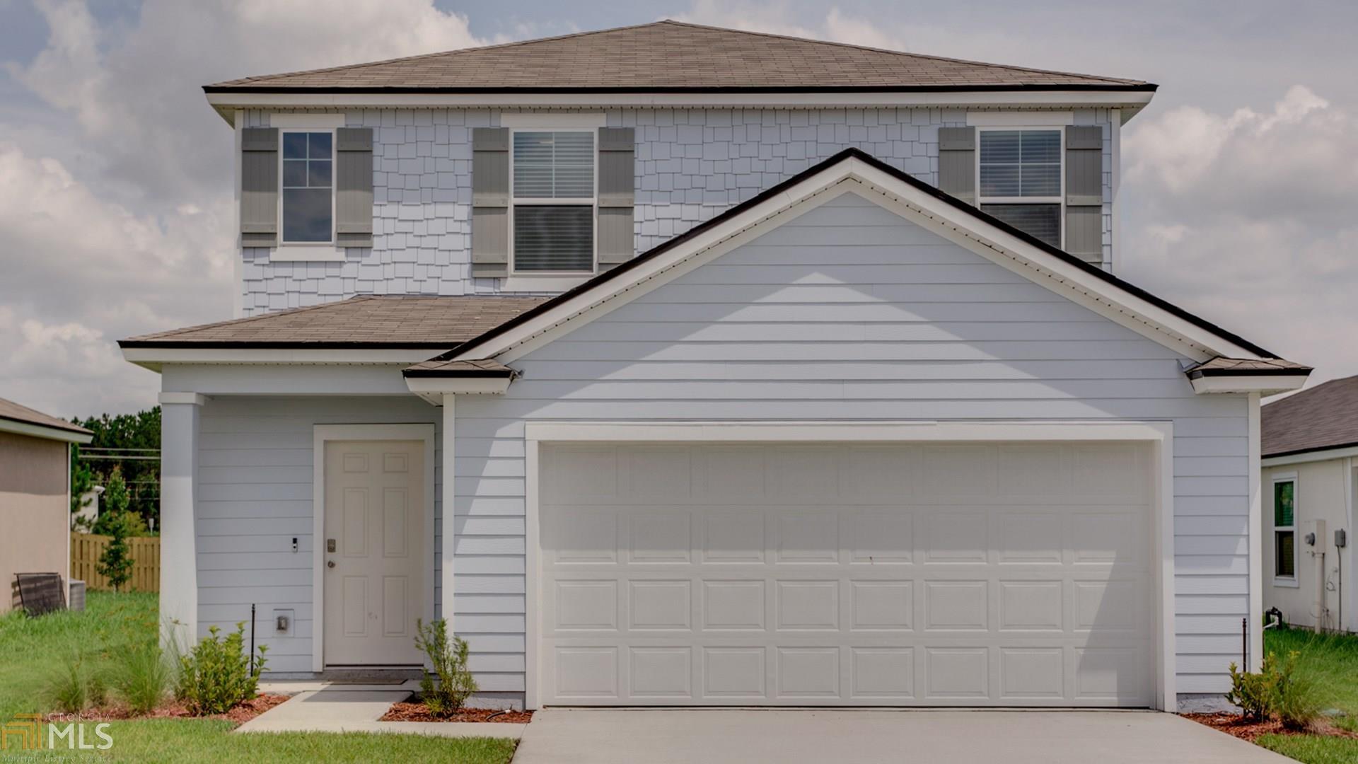 a front view of a house with garage