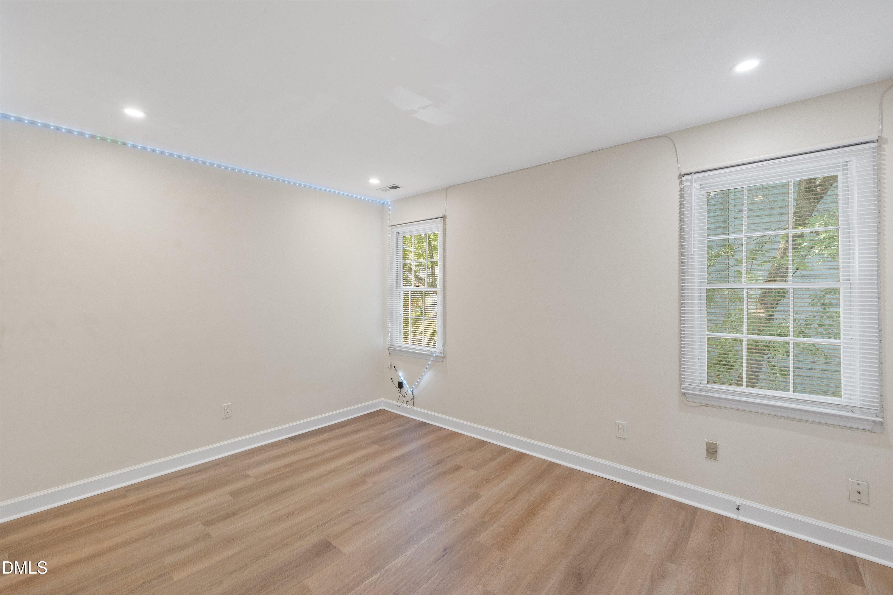 2517 Birchford Court Raleigh, NC 27604 - Photo 46 of 63 an empty room with wooden floor and windows