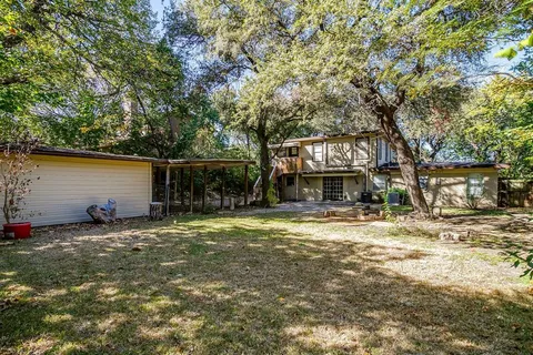 a view of a house with a yard and sitting area