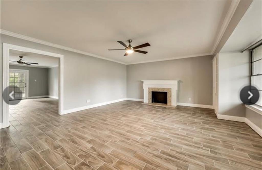 6455 Waverly Way Fort Worth, TX 76116 - Photo 4 of 16 an empty room with fan and fireplace