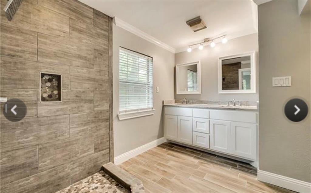 6455 Waverly Way Fort Worth, TX 76116 - Photo 7 of 16 a bathroom with a sink a mirror and a shower