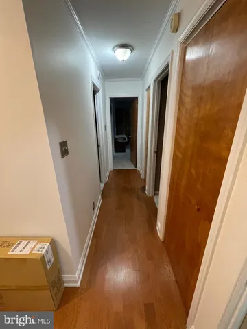 a dining room with wooden floor and large window