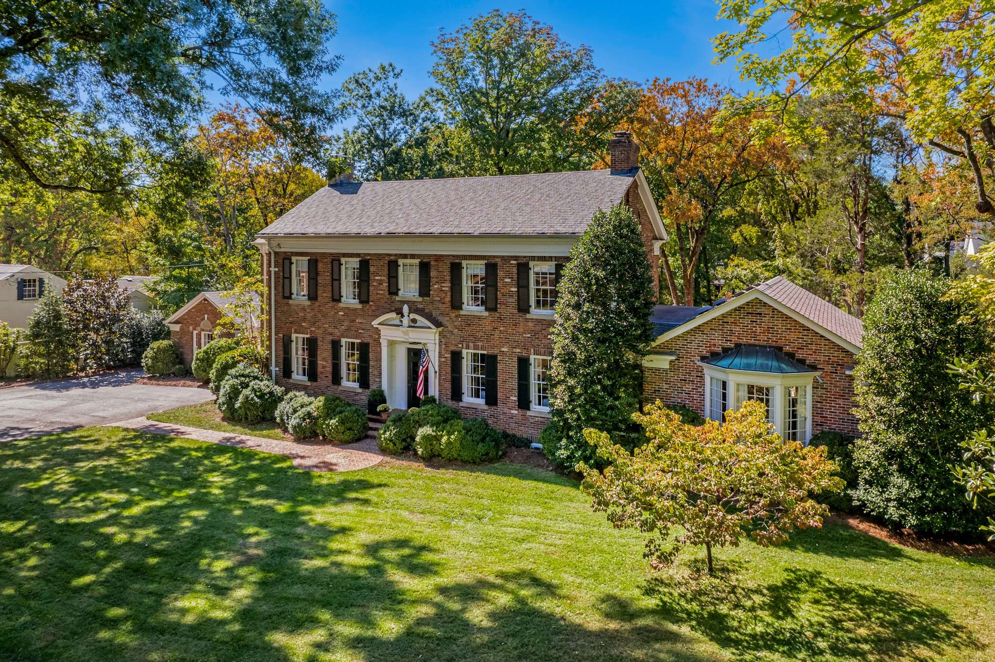 a front view of a house with a garden