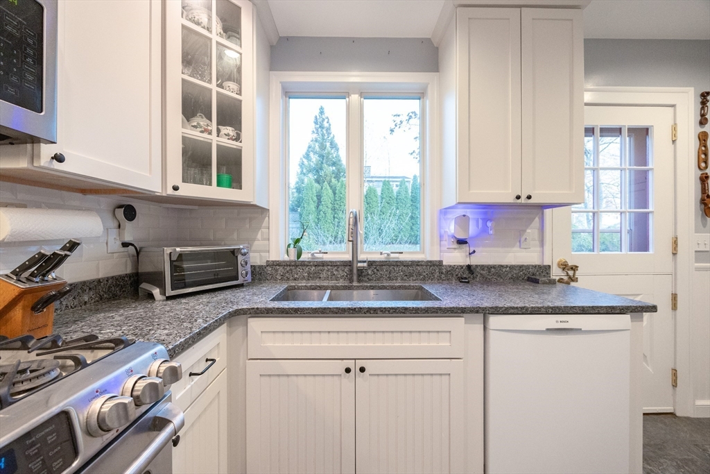 51 Barnstable Street Swampscott, MA 01907 - Photo 3 of 39 a kitchen with granite countertop a sink stove and cabinets