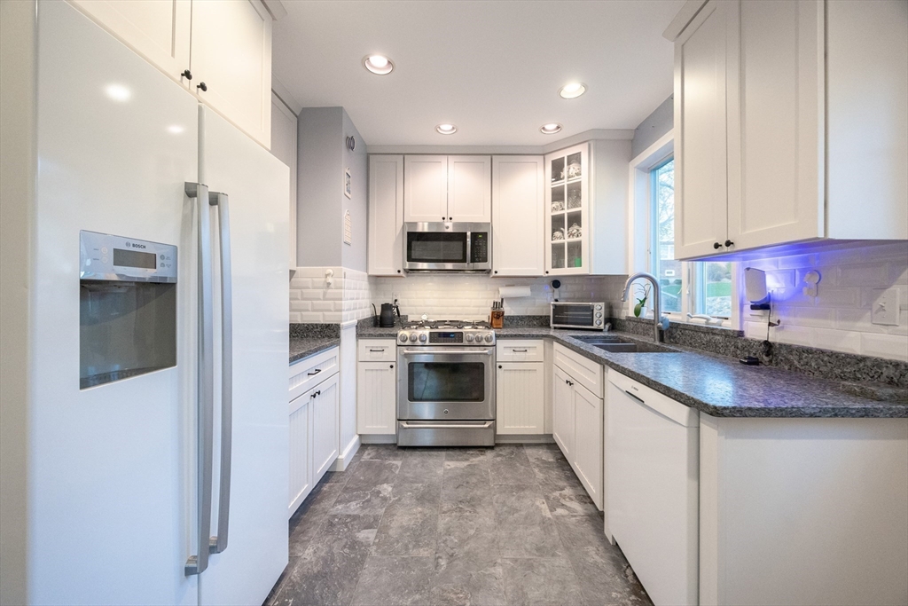 51 Barnstable Street Swampscott, MA 01907 - Photo 38 of 39 a kitchen with a sink cabinets and stainless steel appliances