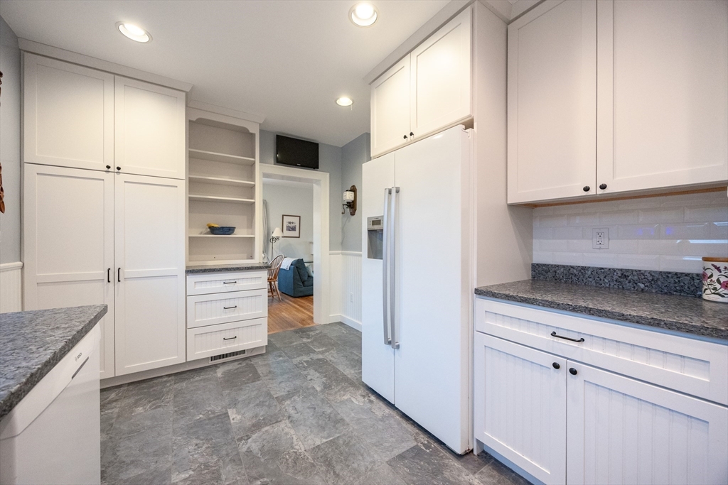 51 Barnstable Street Swampscott, MA 01907 - Photo 5 of 39 a kitchen with white cabinets and refrigerator