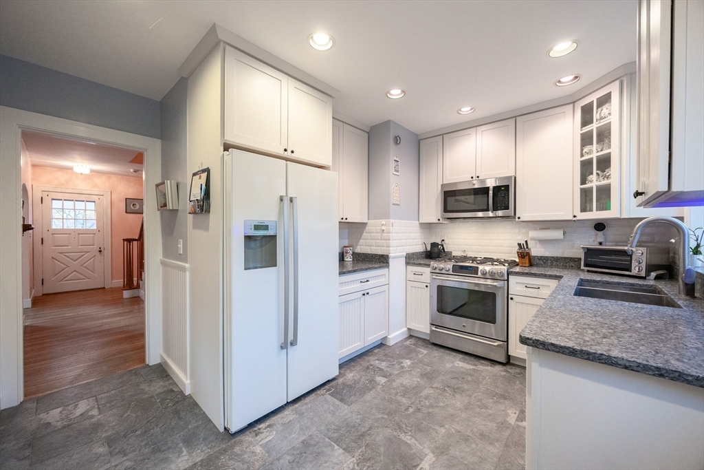 51 Barnstable Street Swampscott, MA 01907 - Photo 6 of 39 a kitchen with a refrigerator a stove top oven a sink and dishwasher
