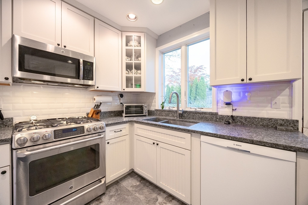 51 Barnstable Street Swampscott, MA 01907 - Photo 7 of 39 a kitchen with stainless steel appliances granite countertop white cabinets a sink and a window
