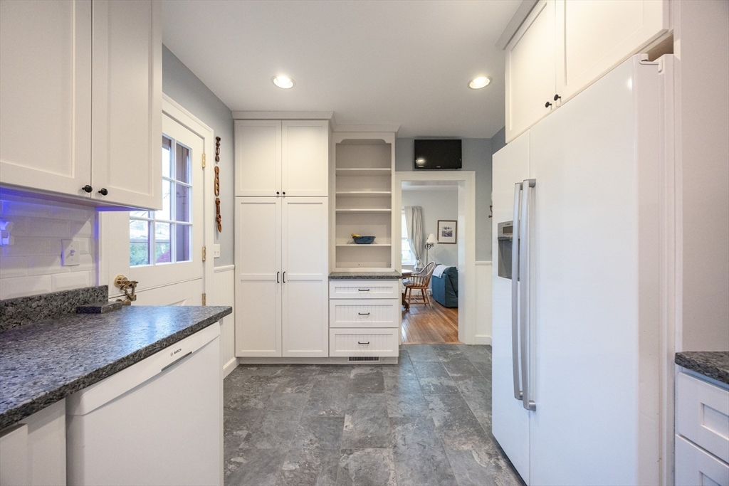 51 Barnstable Street Swampscott, MA 01907 - Photo 8 of 39 a view of a kitchen with refrigerator stove and wooden cabinets
