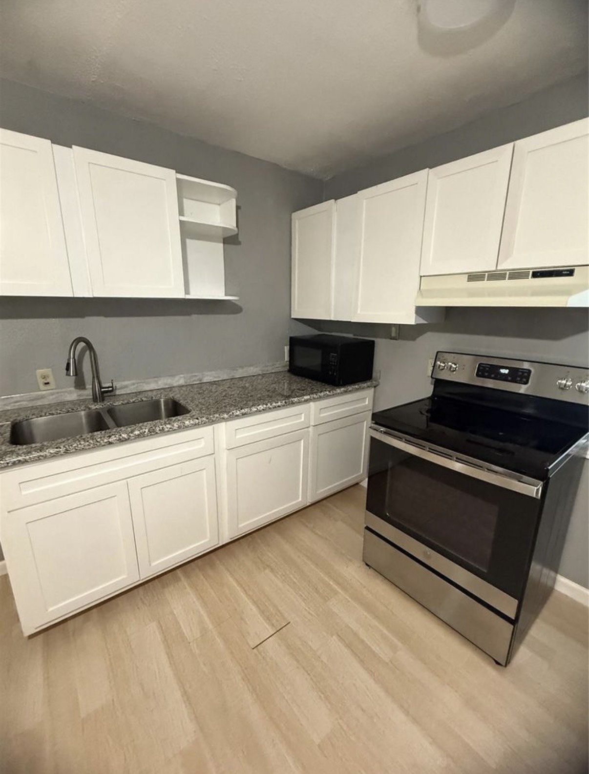 8412 Peekskill Lane Houston, TX 77075 - Photo 11 of 46 a kitchen with granite countertop white cabinets and white appliances