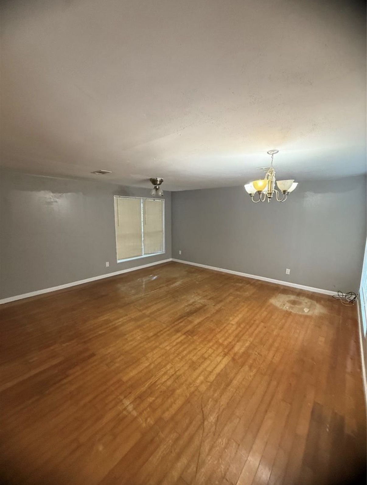 8412 Peekskill Lane Houston, TX 77075 - Photo 7 of 46 an empty room with wooden floor and windows