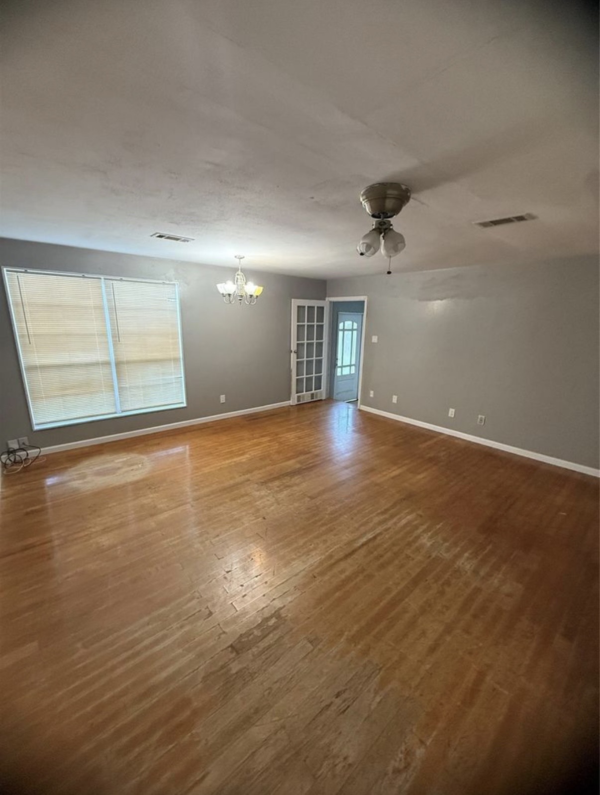 8412 Peekskill Lane Houston, TX 77075 - Photo 8 of 46 an empty room with wooden floor and windows