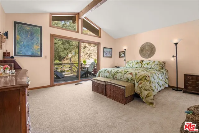 a large bedroom with a bed and glass window