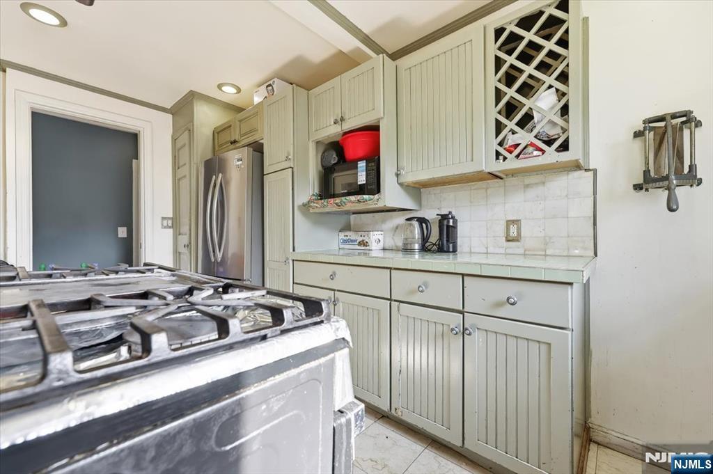 409 Tryon Avenue Englewood, NJ 07631 - Photo 11 of 33 a kitchen with a sink stove and refrigerator