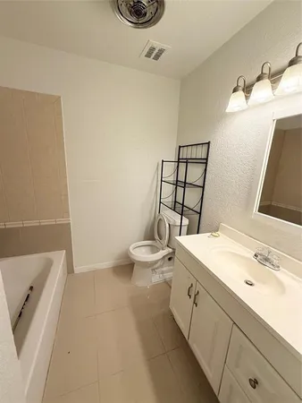 a bathroom with a sink a toilet and mirror