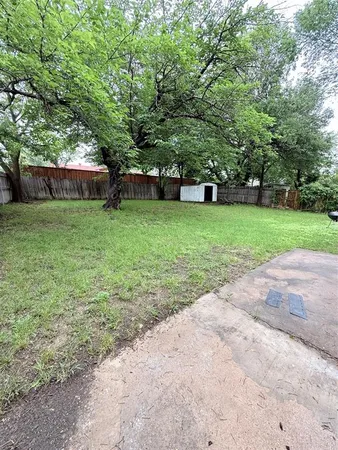a view of a backyard with large trees