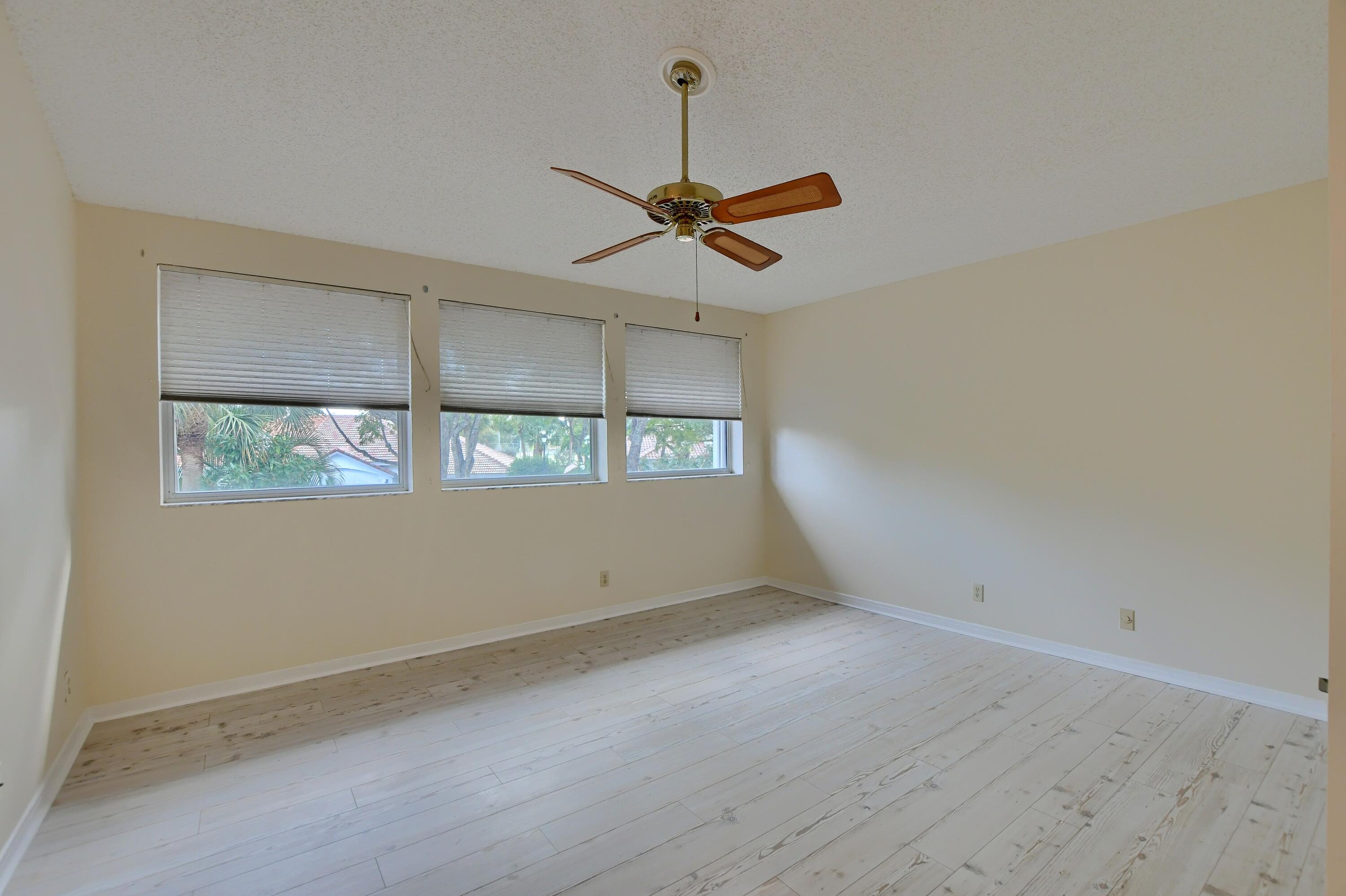 2252 Northwest 53rd Street Boca Raton, FL 33496 - Photo 23 of 41 an empty room with ceiling fan and window