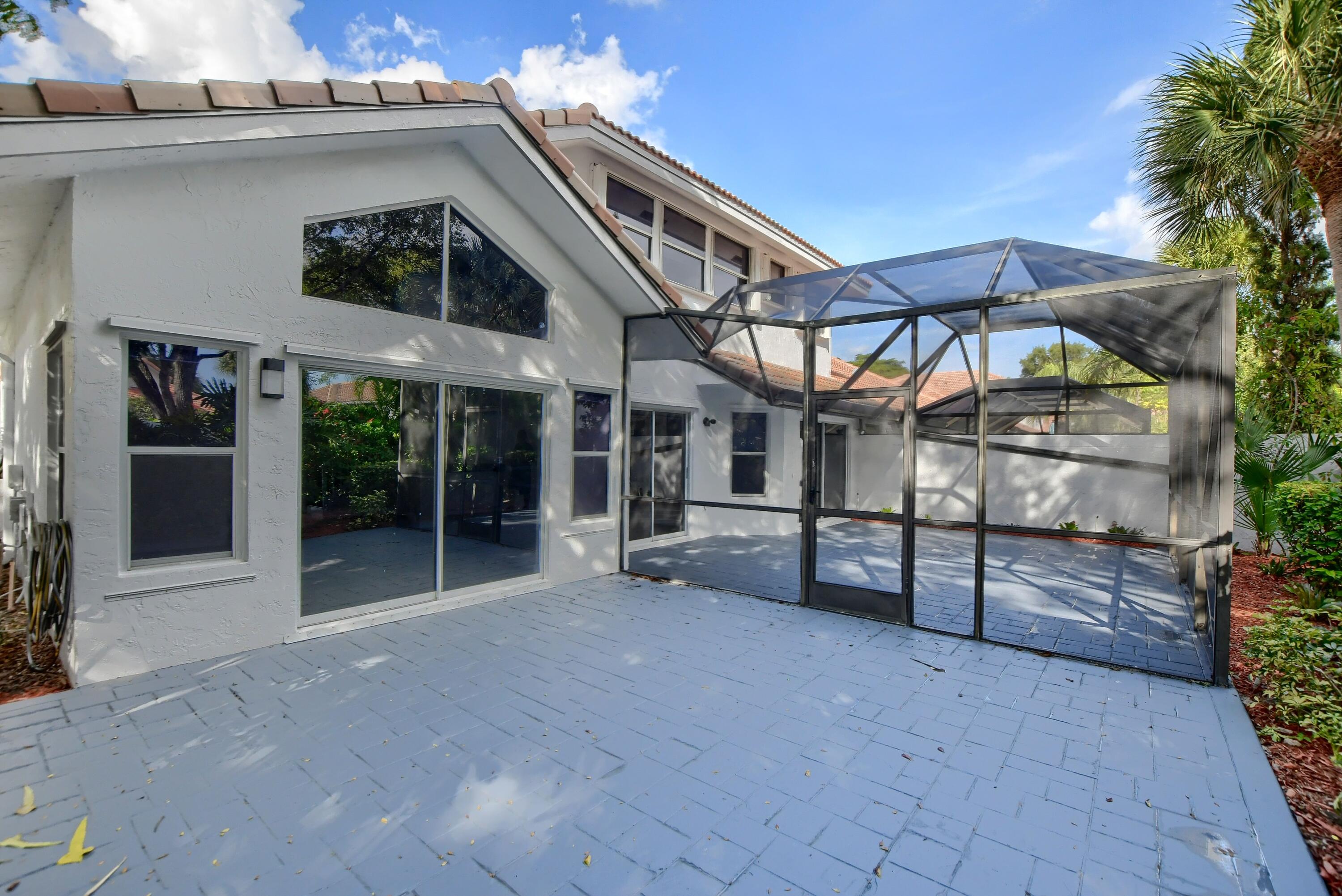 2252 Northwest 53rd Street Boca Raton, FL 33496 - Photo 36 of 41 a view of a house with a large window and potted plants