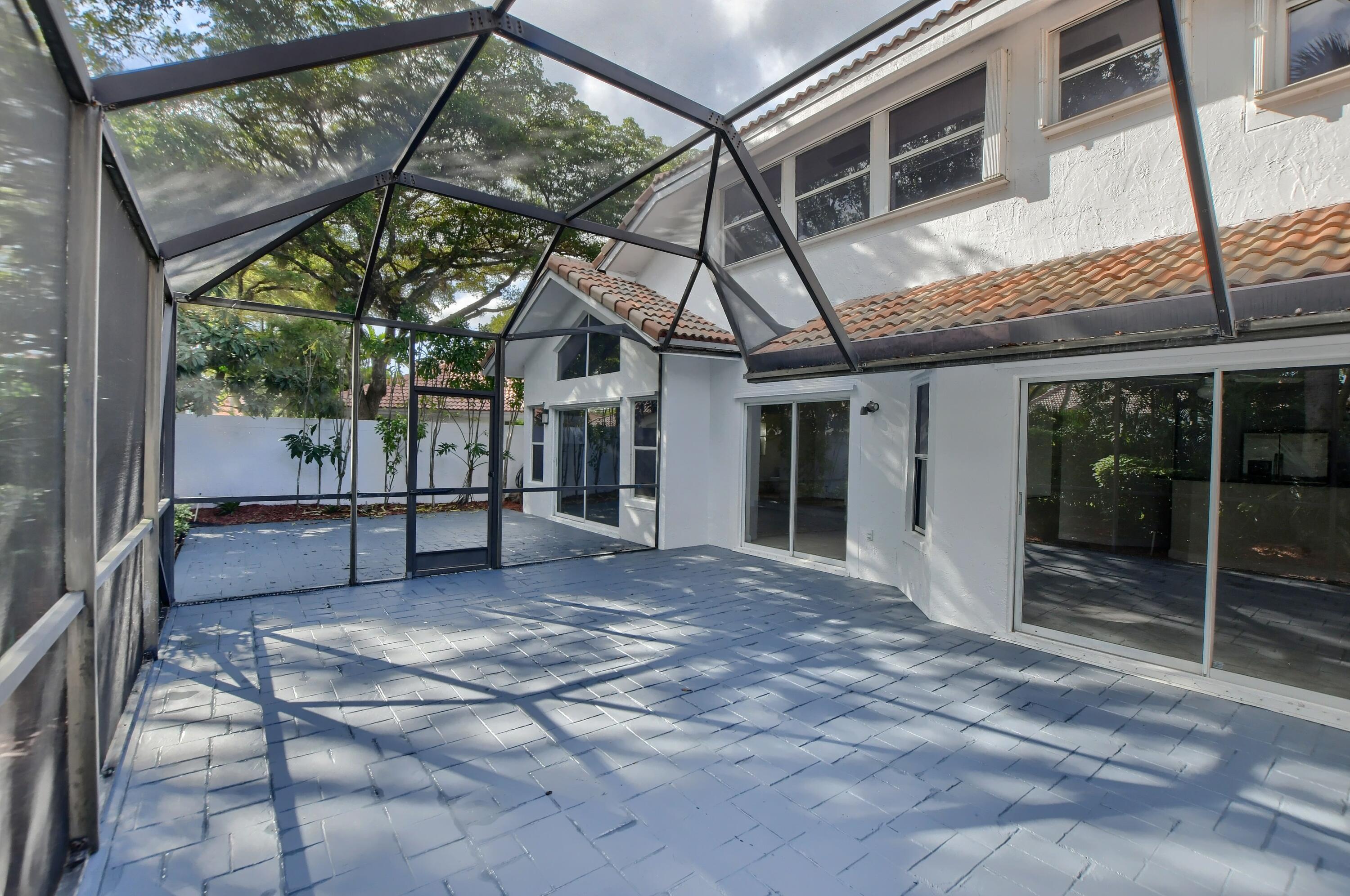 2252 Northwest 53rd Street Boca Raton, FL 33496 - Photo 41 of 41 a view of house with backyard and glass windows