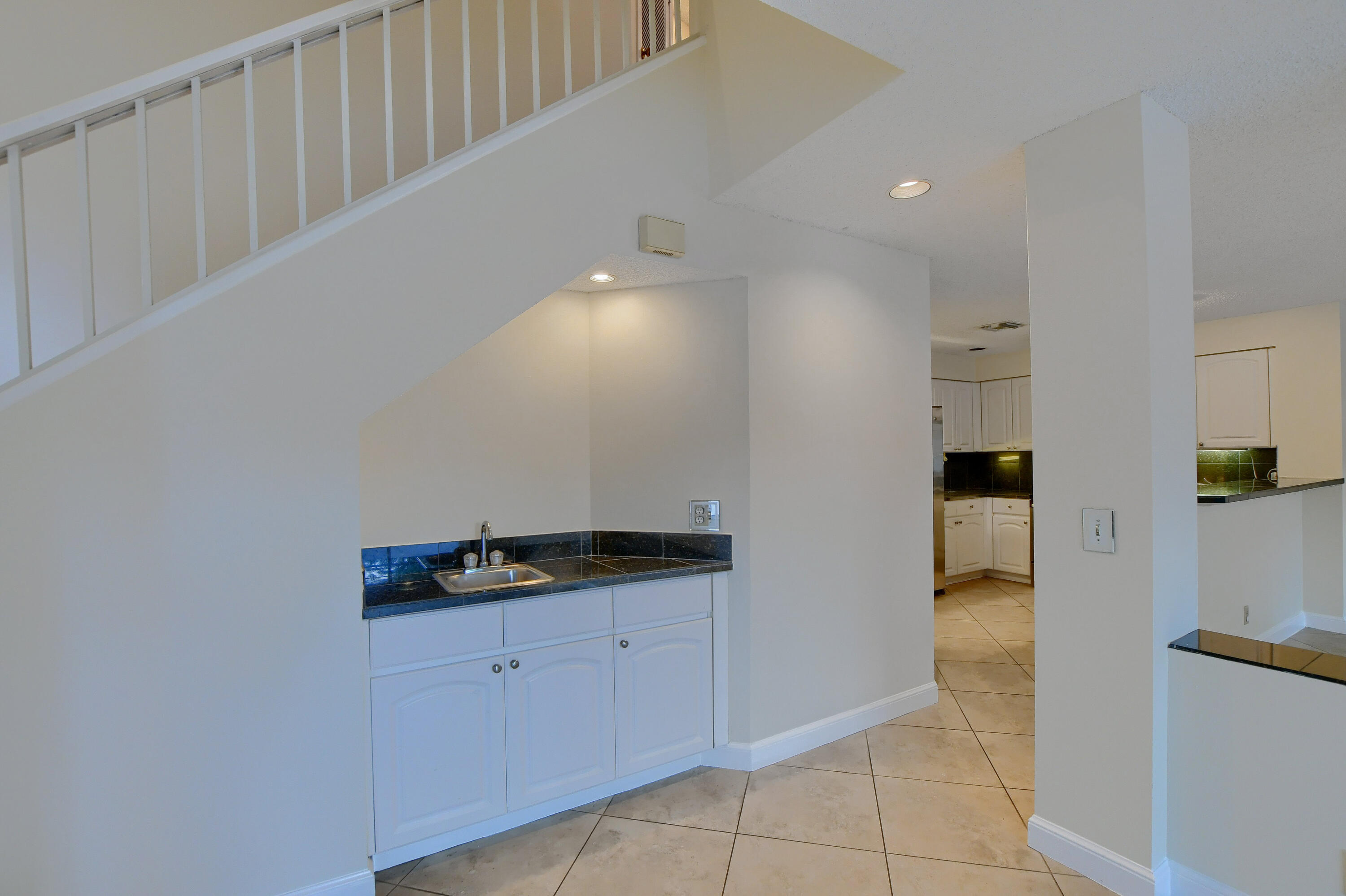 2252 Northwest 53rd Street Boca Raton, FL 33496 - Photo 10 of 41 a kitchen with white cabinets and white appliances