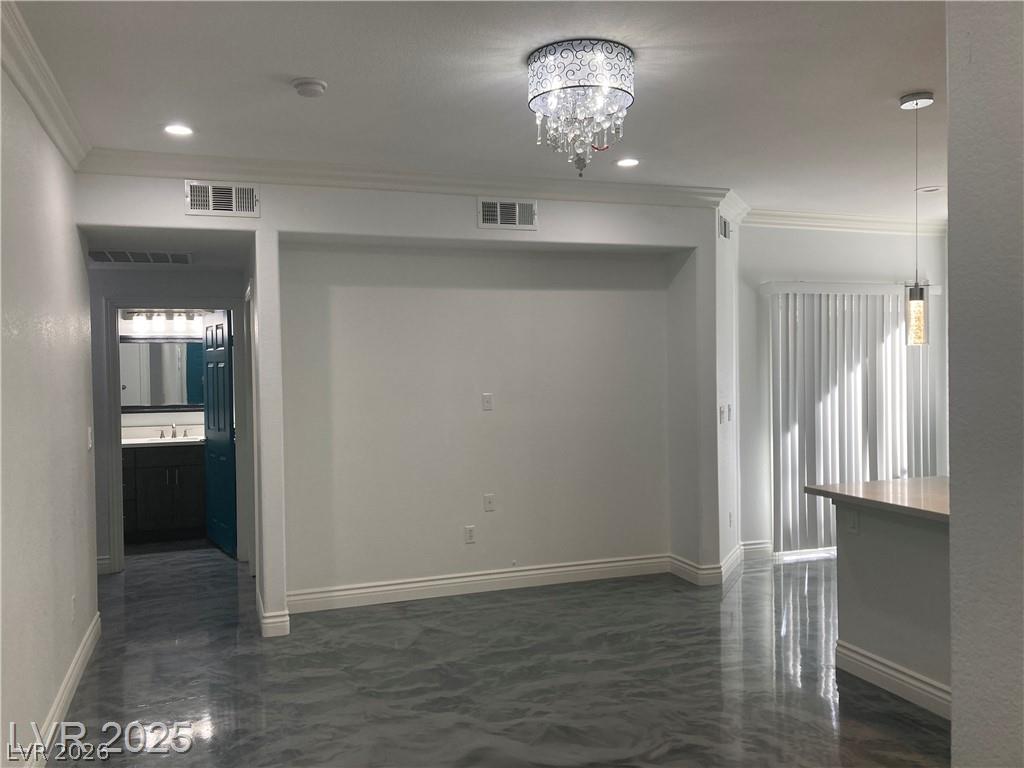 9050 West Warm Springs Road, Unit 1027 Las Vegas, NV 89148 - Photo 9 of 44 The living area features a decorative chandelier and sleek tile flooring.