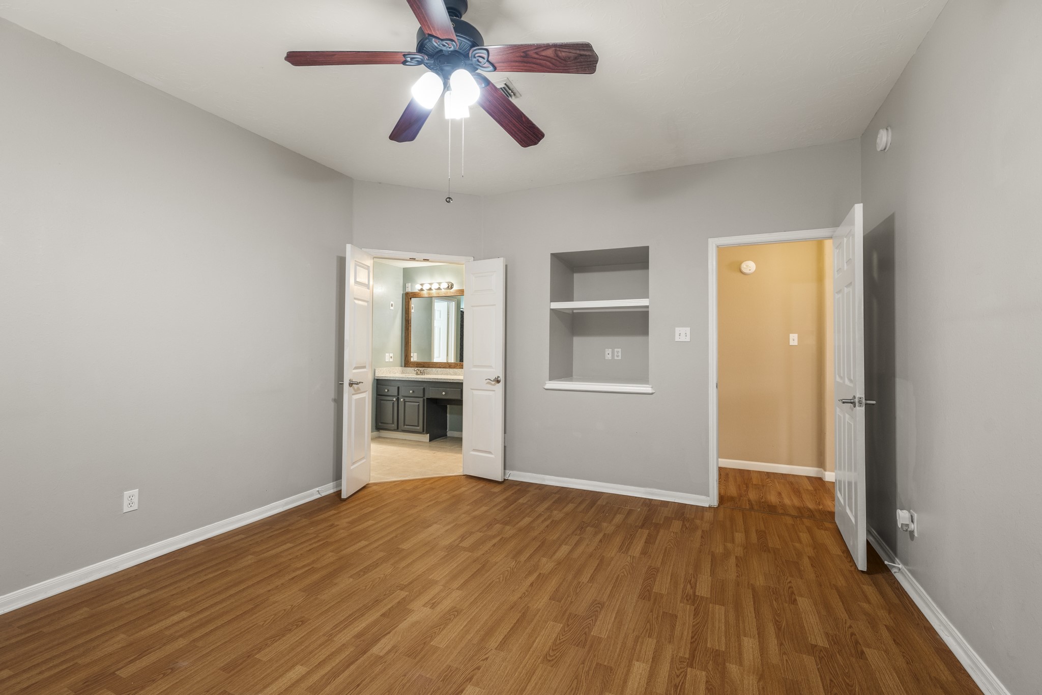 9109 Benwick Street Spring, TX 77379 - Photo 16 of 28 a view of empty room with wooden floor and ceiling fan
