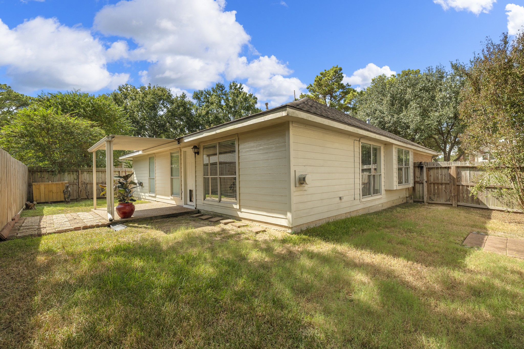 9109 Benwick Street Spring, TX 77379 - Photo 24 of 28 a view of a house with backyard and a tree