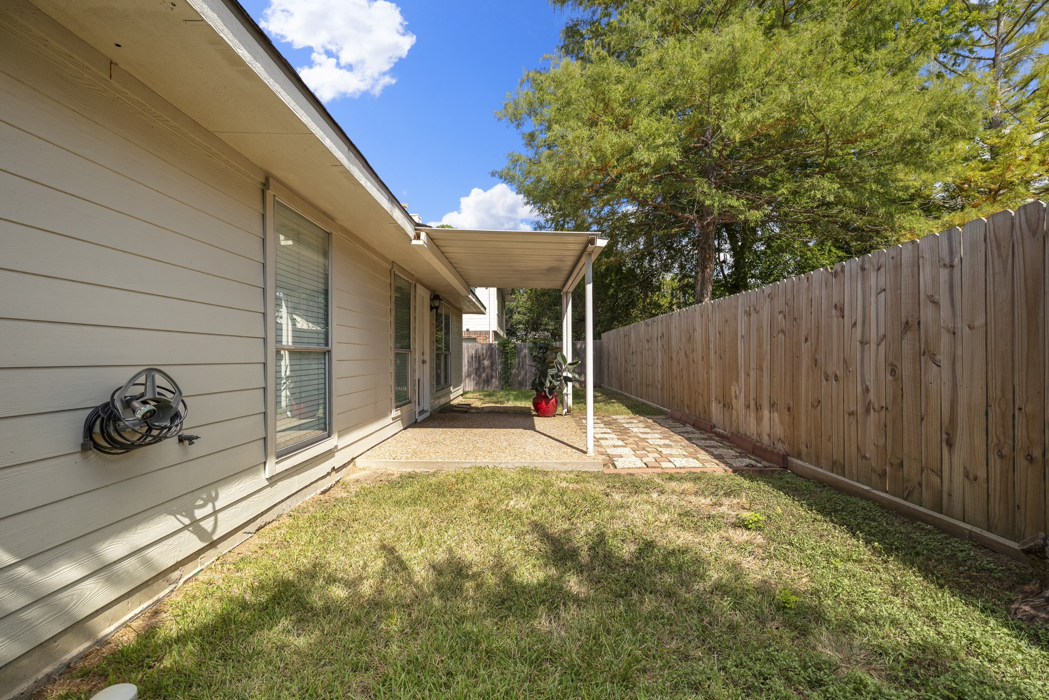 9109 Benwick Street Spring, TX 77379 - Photo 26 of 28 a view of a backyard with door