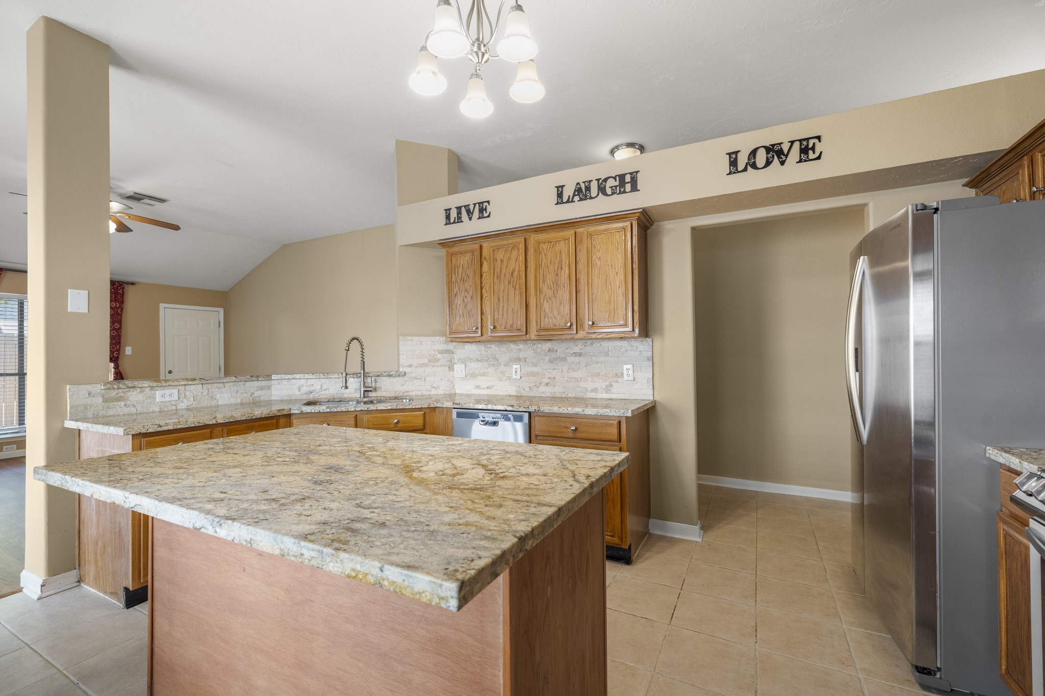 9109 Benwick Street Spring, TX 77379 - Photo 9 of 28 a kitchen with stainless steel appliances granite countertop a sink stove and refrigerator