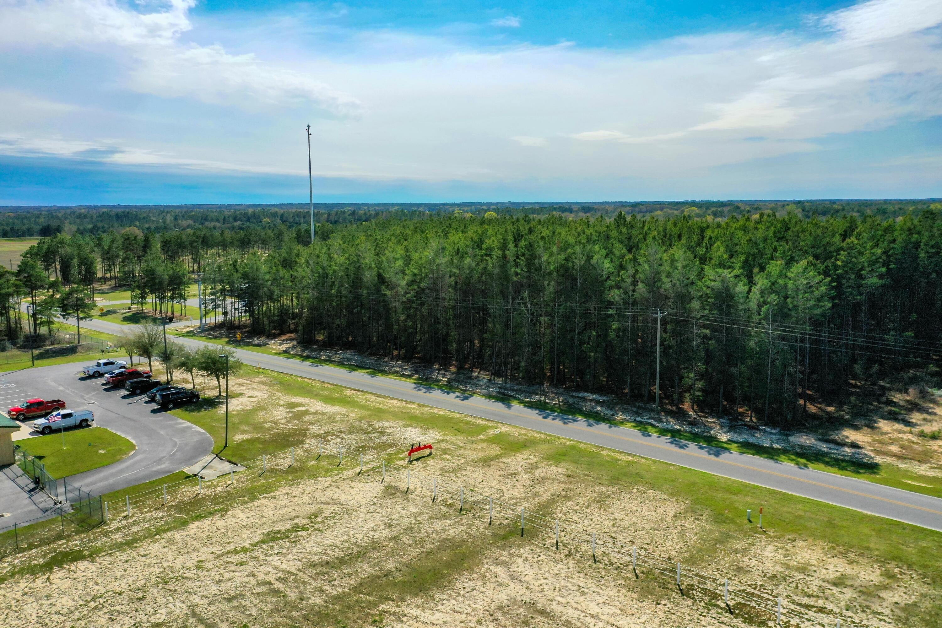 Xxx Triple G Road DeFuniak Springs, FL 32433 - Photo 12 of 16 a view of swimming pool with lawn chairs plants and large tree