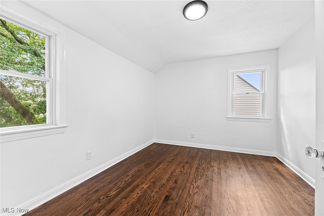 7719 Ackley Road Parma, OH 44129 - Photo 24 of 35 Spare room with dark wood-type flooring and lofted ceiling