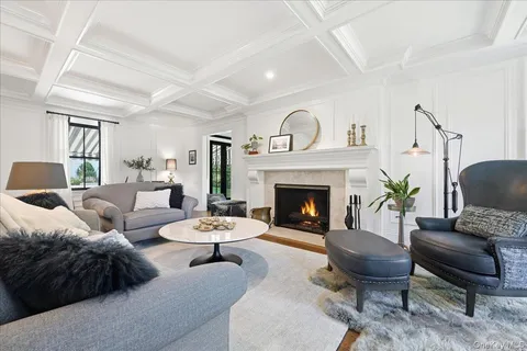 a living room with furniture fireplace and window