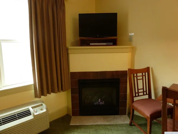 a living room with furniture and a lamp