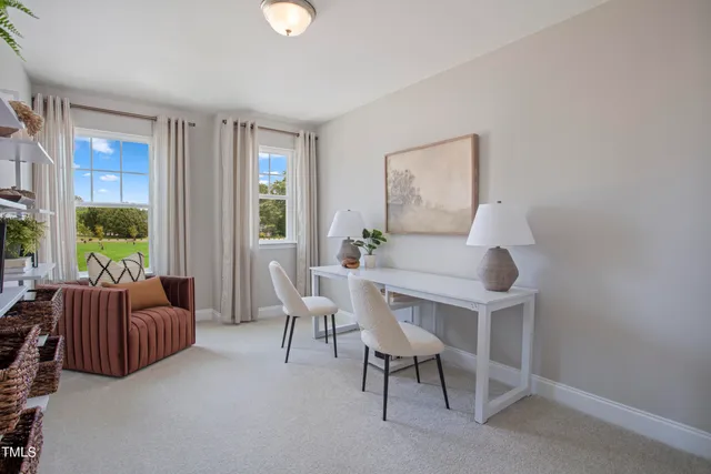 a kitchen with stainless steel appliances a table chairs refrigerator and microwave