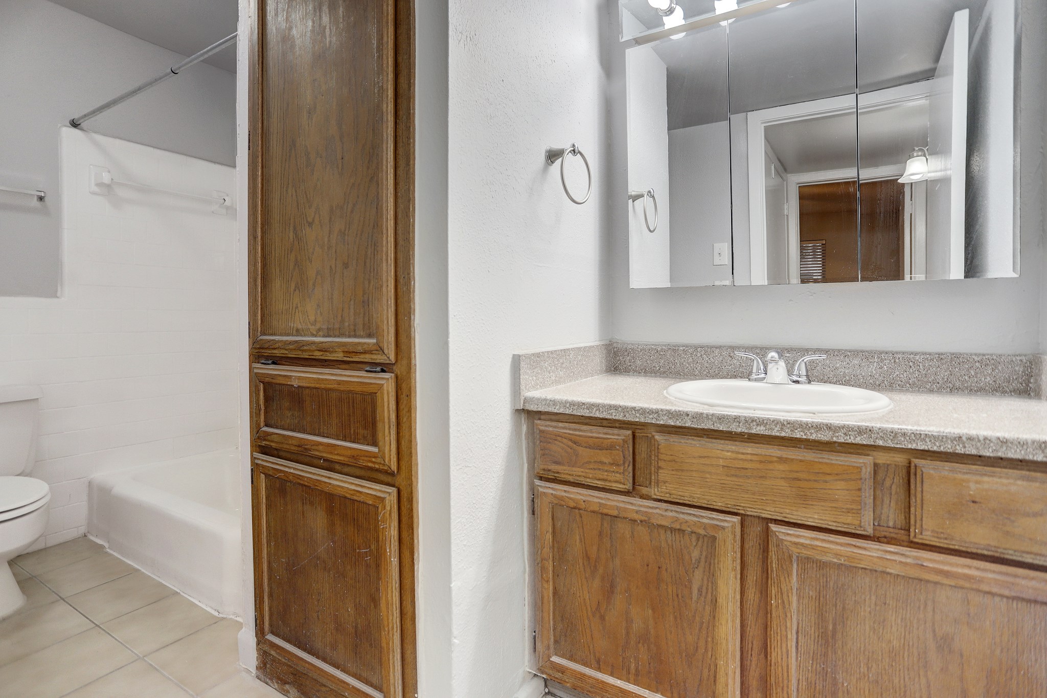 1645 West Main Street, Unit 6 Houston, TX 77006 - Photo 4 of 10 a bathroom with a granite countertop sink and a mirror