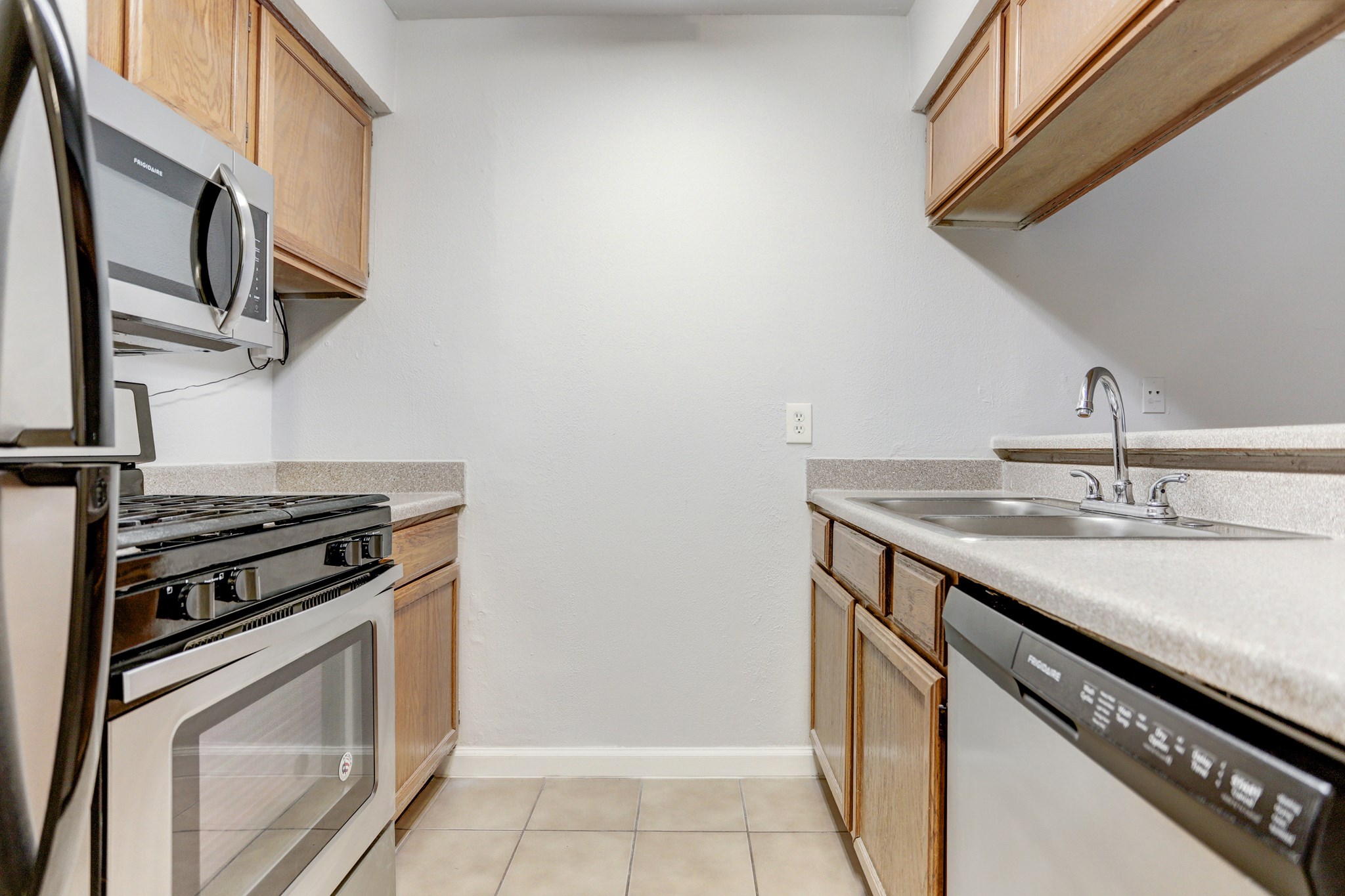 1645 West Main Street, Unit 6 Houston, TX 77006 - Photo 6 of 10 a kitchen with stainless steel appliances granite countertop a stove and a sink