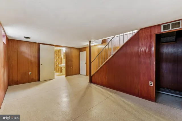 a bathroom with a sink and mirror with bathtub